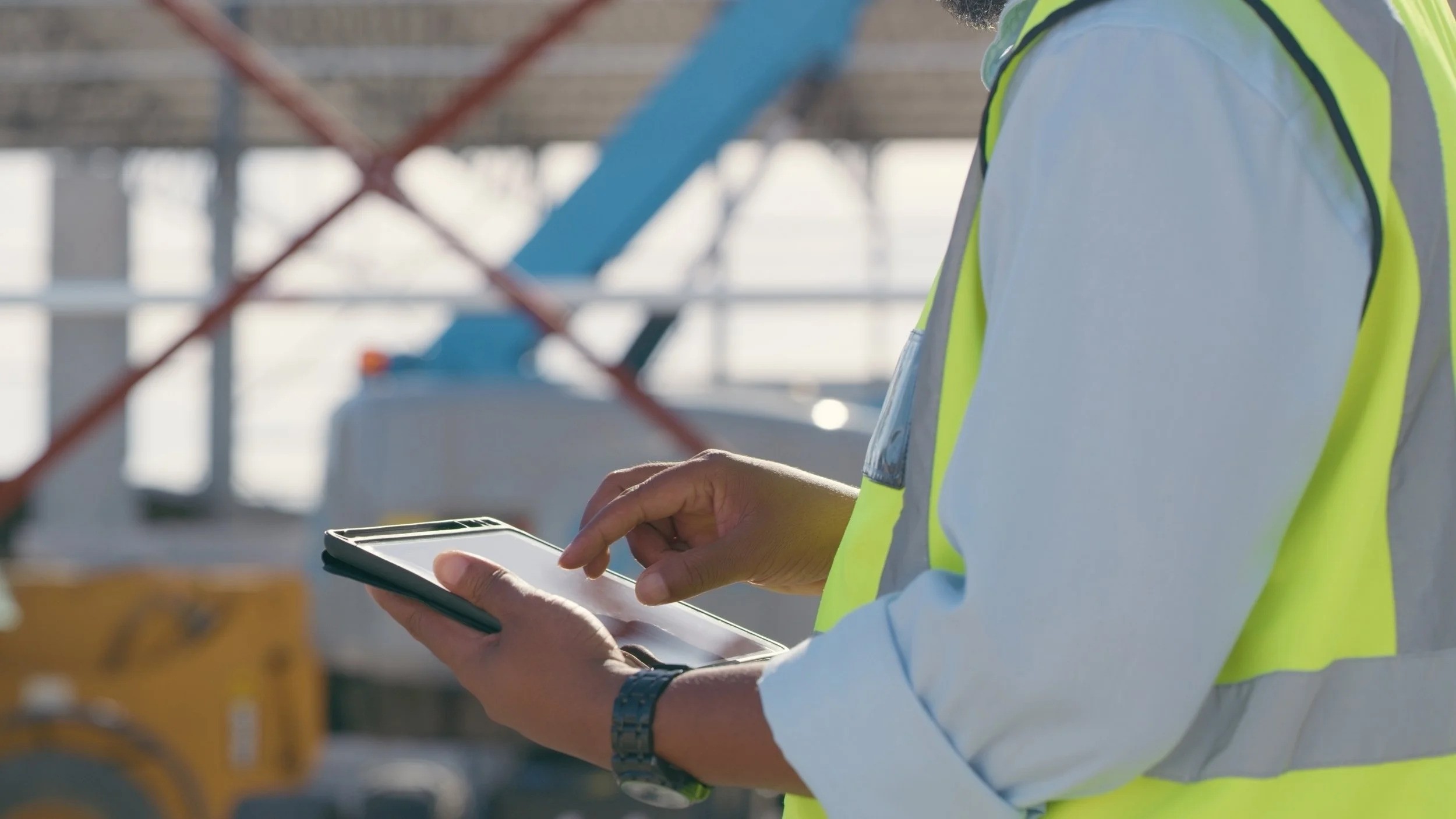 Man in hi-vis jacket at a construction site